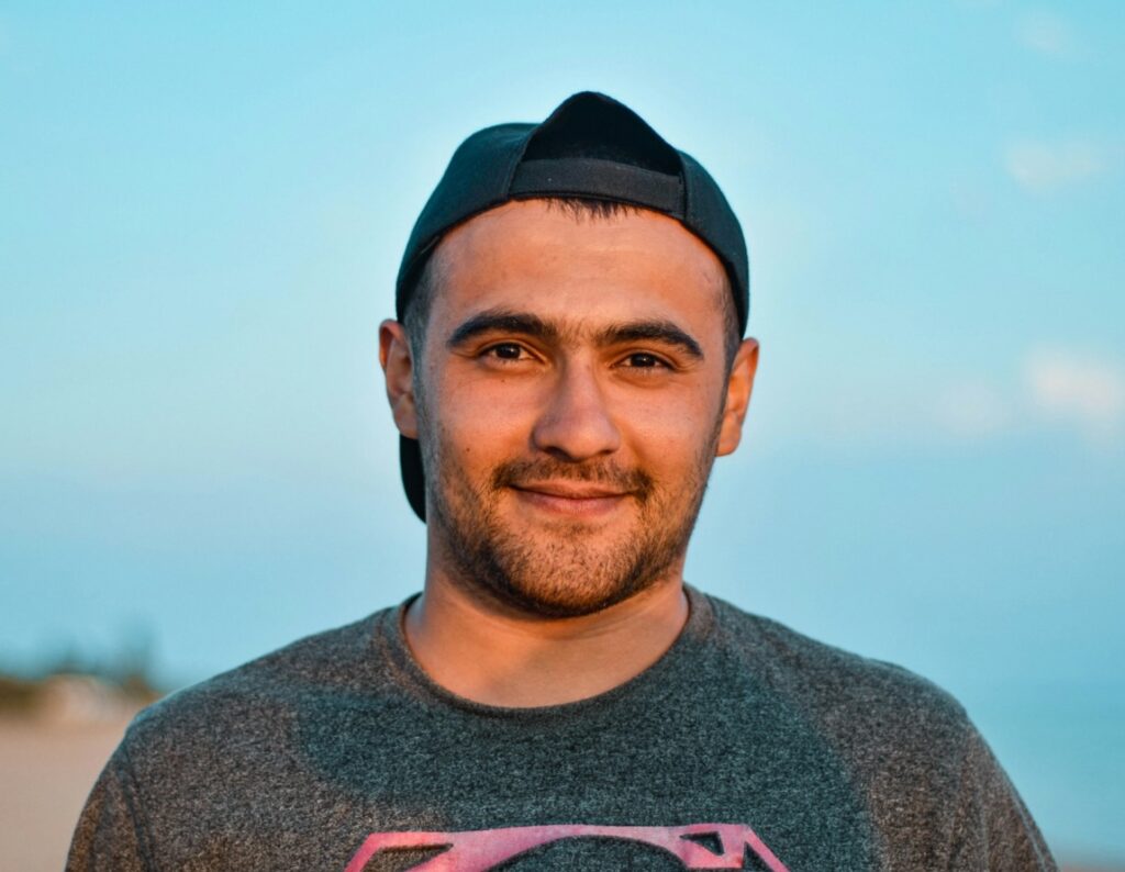 A healthy young main smiling into the camera